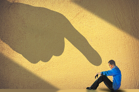 The finger of blame is pointed at this guy in a shadowy 3-d illustration.