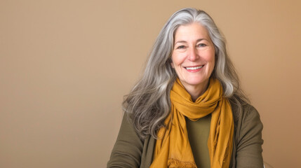 Elegant Senior Woman with Silver Hair and Mustard Scarf Smiling Gently
