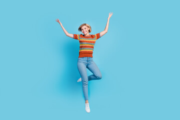 Full length photo of adorable lovely positive girl wear strited t-shirt jeans flying raising arms...