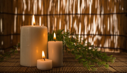 interior decoration with three lit candles in the foreground. Spa decor 