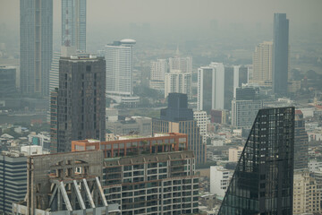 Hazy Bangkok Skyline Featuring Contemporary and Classic Structures