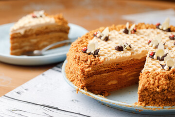 Honey cake with honeycombs and chocolate bee, flat lay. Top view.