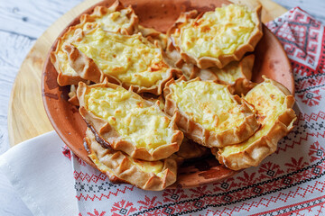 Karelian plays or Karjalanpiirakka. Traditional finnish or north russian pastry on clay plate. Top...
