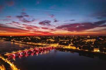 Fototapeta na wymiar Golden Hues Envelop Blois: Captivating Sunset Paints City and Bridge in Luminous Tones
