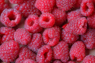 Background of fresh sweet red raspberries arranged together representing concept of healthy diet. Close up.