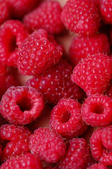 Background of fresh sweet red raspberries arranged together representing concept of healthy diet. Close up.