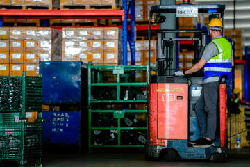 factory man driving forklift car working in distribution warehouse. factory worker teammates working beside stacks of cargo. Group of Diversity engineer factory people meeting. © ultramansk