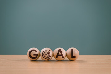 Goal setting planning focus for future. Goal aim target concept. Hand push target board on wooden...