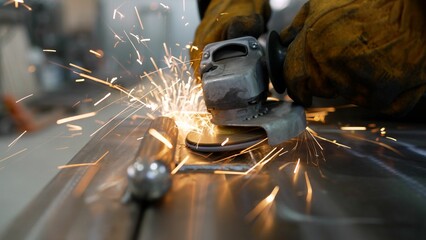 A metal saw close-up on the sides flies with bright sparks from an angle grinder. Hot sparks when...
