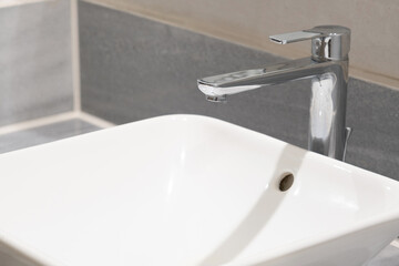 faucet for water and white sink on marble counter