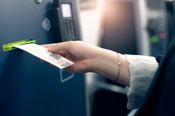 automatic ticket terminal,  young woman buying tickets for public transportation