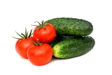 Cucumbers and tomatoes in one pile lie on a white background.
