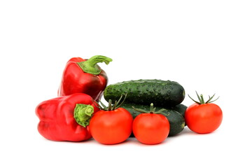  Cucumbers and tomatoes in one pile lie on a white background.