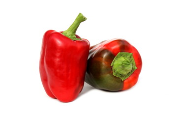 Two red sweet peppers lie on a white background.