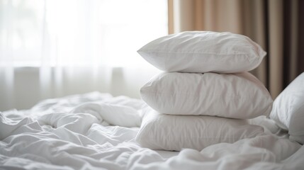 Fototapeta na wymiar a stack of white pillows sitting comforter bedspread.