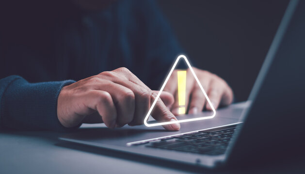 user works with laptop computer that has an error warning triangle sign. concept of a warning or notification Computer virus detection Data protection network security system cyber security system