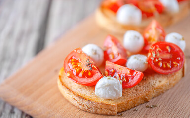 Bruschetta with mozzarella and tomatoes. Vegetarian food. Healthy eating