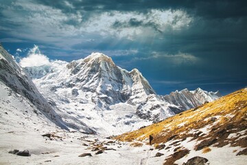 Beautiful view of majestic snow-covered mountains and dramatic cloudy sky. Annapurna, Nepal