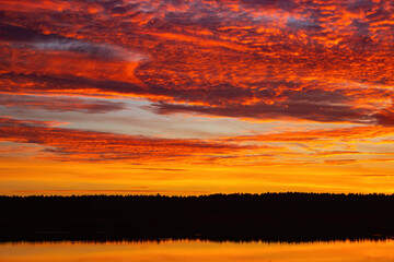 Beautiful sky background with clouds after sunset. Red yellow sky.