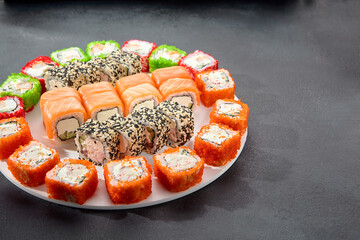 Assorted sushi rolls with salmon, tobiko caviar, and sesame seeds, a feast for sushi enthusiasts