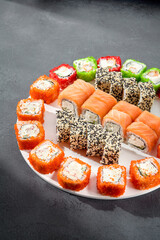 Assorted sushi rolls with salmon, tobiko caviar, and sesame seeds, a feast for sushi enthusiasts