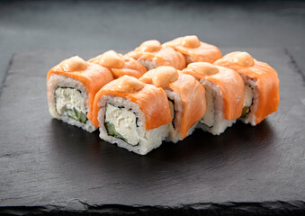 Baked Philadelphia sushi rolls with spicy sauce, offering a creamy and tangy taste in each bite