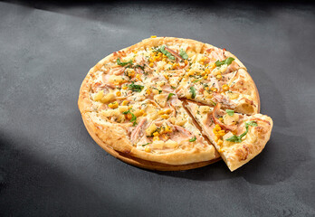 Hawaiian pizza with chicken, pineapple, and corn, a sweet and savory combination on a perfectly baked crust