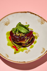 Beetroot mille-feuille with pesto sauce creatively plated, ideal for fresh and healthy menu options