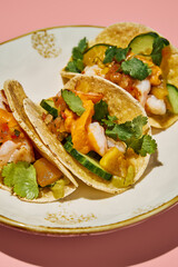 Close-up of sweet potato mousse and turkey tacos on a vintage plate, with a pink background