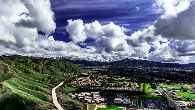 Aerial view of Yucaipa, California after a winter storm with snow covered San Bernardino Mountains, Crafton Hills, Chapman Heights and Yucaipa Valley  Golf Course