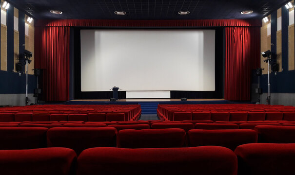 empty cinema auditorium with red chairs