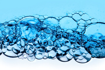 Close-up of bubbles in water, scientific background of cosmetic essence, serum under a microscope. Hydration The concept of developing cosmetics for skin care. Beauty Hydration background