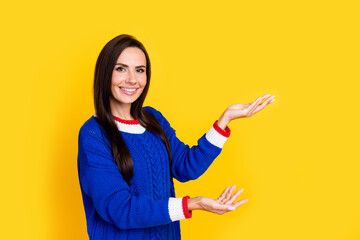 Portrait photo of young smiling woman satisfied demonstrate two fresh vegetables promoter hypermarket isolated on yellow color background