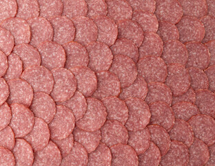 sliced salami sausage as background, close up