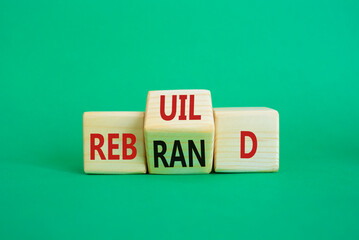 Rebuild and Rebrand symbol. Wooden cubes with words Rebrand and Rebuild. Beautiful green background. Rebuild Rebrand and Business concept. Copy space