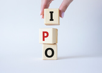 IPO- Initial Public Offering symbol. Concept word IPO on wooden cubes. Businessman hand. Beautiful...