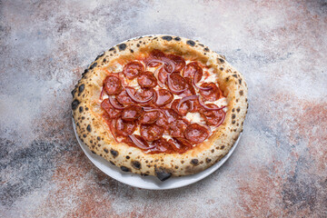 Pizza with salami and mozzarella cheese