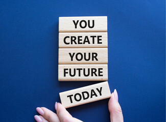 Future and development symbol. Wooden blocks with words You Create your Future today. Businessman hand. Beautiful deep blue background. Business and Future and development concept. Copy space.
