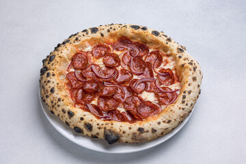 Pizza with salami and mozzarella cheese