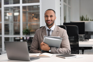 Happy man with folders working at table in office. Lawyer, businessman, accountant or manager