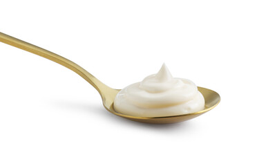 Golden spoon with mayonnaise isolated on white