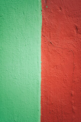 Green and red painting on a house facade in San Cristobal de las Casas, Mexico