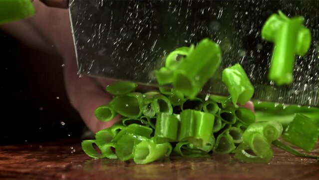 A cook chops green onions. Filmed on a high-speed camera at 1000 fps. High quality FullHD footage