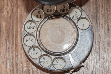 Close-up shot of the dial of an antique wooden telephone