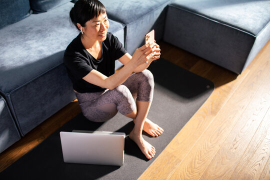 Close up Asian woman holding smartphone at home