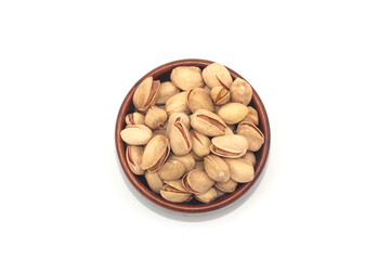 Pistachio nuts, pistachios in Wooden Bowl Isolated on a white background. 