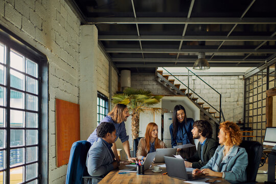 Team meeting of young diverse professionals in office