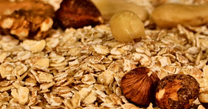 Extreme close up video of spelled flakes with other breakfast cereals and nuts on a turning plate. 