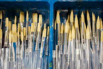 Set of art brushes of different sizes inside a box