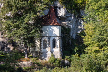 old pilgrimage church of St. Wendel am Stein directly on the mountain with trees in summer